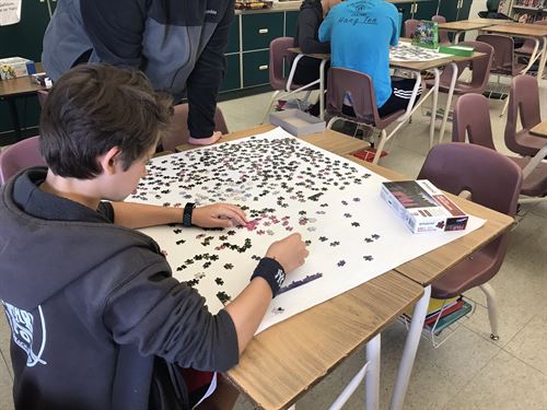 student working jigsaw puzzle 